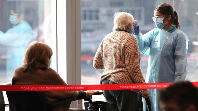 Passengers are checked for coronavirus symptoms at Sydney Airport after Qantas flight QF436 from Melbourne on Sunday. Picture: Damian Shaw