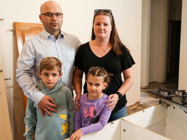 NEWS ADVSewerage FloodGerald & Katie Barrie and kids Charlie 7, & Maggie 6 in their kitchen which has been stripped after the sewerage flooding.Gerald's house has been flooded with sewerage after a dry tree root caused a pipe to burst. Image/Russell Millard Photography