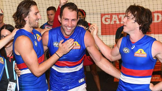 Travis Cloke celebrates the Bulldogs win with Marcus Bontempelli and Liam Picken.