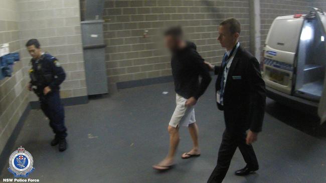 Carter is led into St Mary’s Police Station by detectives from State Crime Command’s Raptor Squad on Tuesday. Picture: NSW Police