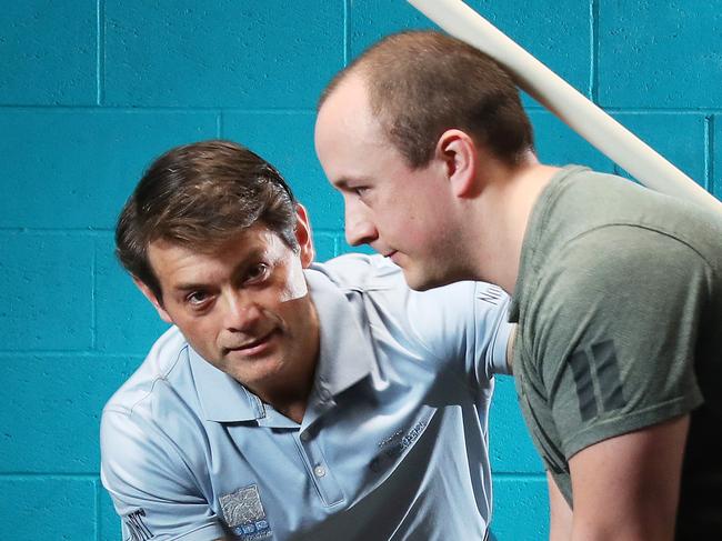 Spinal surgeon Dr David Johnson with Josh Hill, 33, who has suffered from lower back pain for years, Functional Movement Training, Woolloongabba. Photographer: Liam Kidston