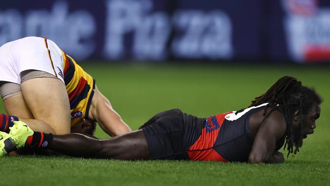 AFL Round 17. Essendon vs Adelaide at Marvel Stadium, Melbourne. 09/07/2021. Anthony McDonald-Tipungwuti of the Bombers and Tom Doedee of the Crows after colliding during a marking contest 1st qtr. Pic: Michael Klein