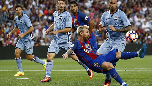 FC Barcelona's Lionel Messi, second right, sets up a goal for Luis Suarez.