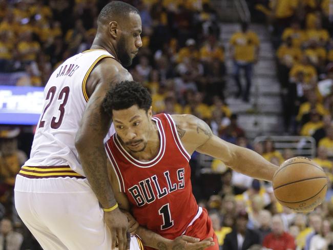 Chicago Bulls guard Derrick Rose (1) drives around Cleveland Cavaliers forward LeBron James (23) during the second half of Game 1 in a second-round NBA basketball playoff series Monday, May 4, 2015, in Cleveland. (AP Photo/Tony Dejak)