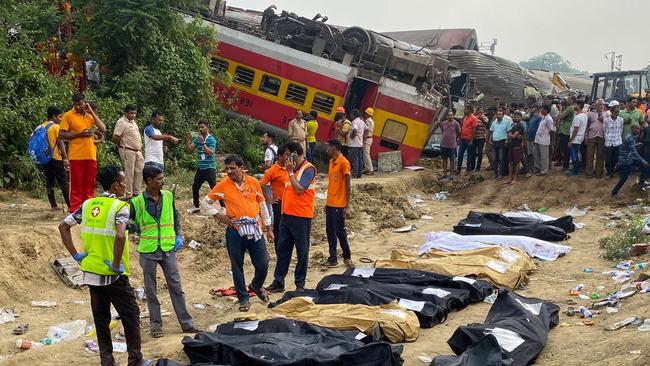 Medical workers stand in front of the bodies of victims killed. Picture: AFP