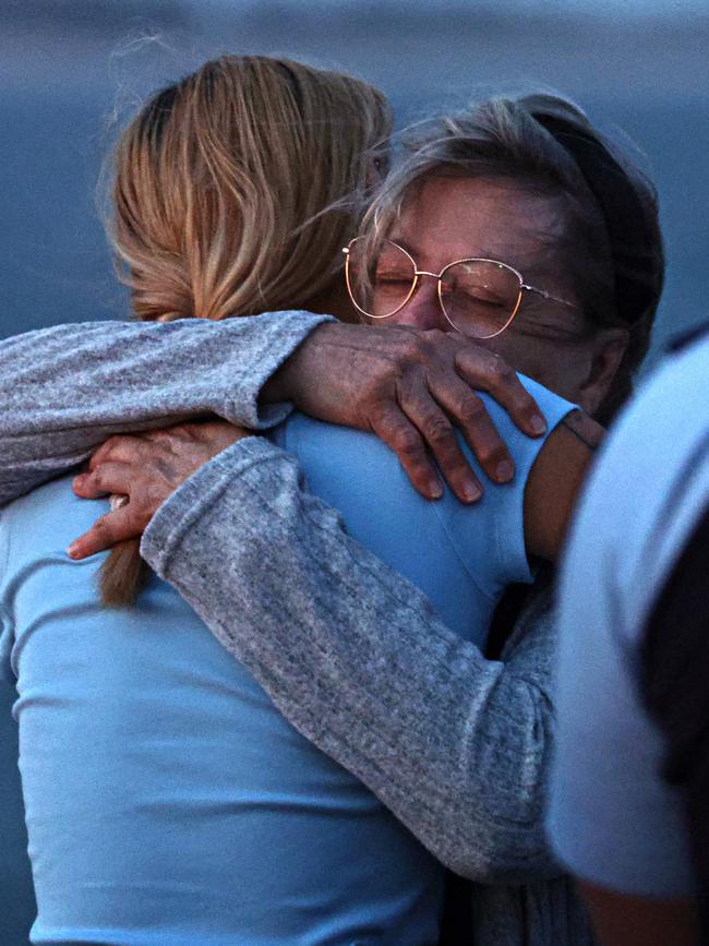 Sally Callahan, mother of James Callahan, hugs a friend at the vigil. Picture: Adam Yip