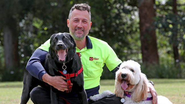 Richard Pump with Zack and Poppy, the two dogs he rescued from a burning home. Picture: Toby Zerna