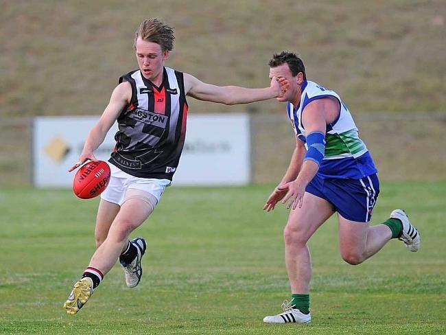 Kingston footballer Trent Rothall, left, playing in match against K-L United. 