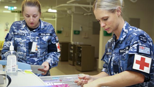 Royal Australian Air Force Medical Technician, Corporal Megan Macauslan, carries out a check on the emergency trolley in the North West Regional Hospital after the hospital's formal handover from contracted cleaning personnel, during COVID-19. Picture: SUPPLIED