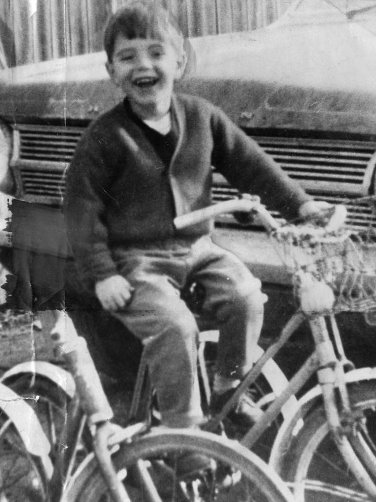 <p>Grant Beaumont is all smiles on a tricycle</p>