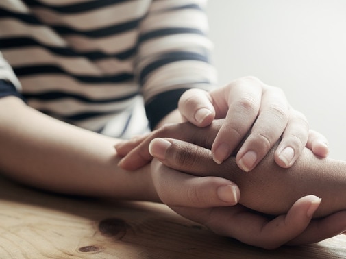 Shot of an unidentifiable woman consoling her friend by holding her handPsychologyMental health