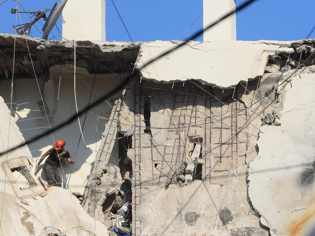 A rescuer inspects the destruction on a residential building whose top two floors were hit by an Israeli strike in Beirut’s south on Tuesday. Picture: AFP