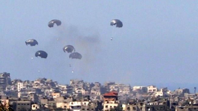 A picture taken from southern Israel on March 6, 2024 shows smoke billowing amid destroyed buildings in the Gaza Strip