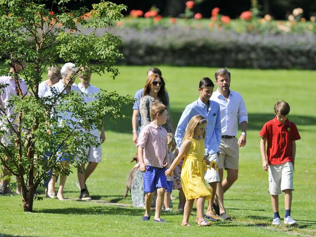 The Danish royals stroll through their summer residence.