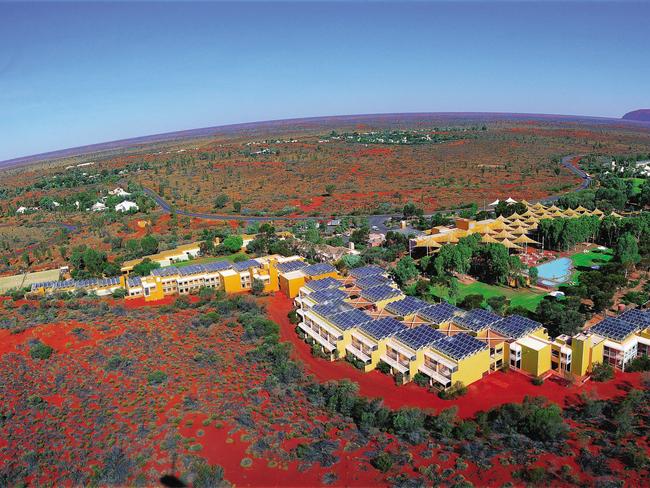 An aerial shot of Ayers Rock Resort with Uluru in the background. Picture; Voyages Tourism Australia