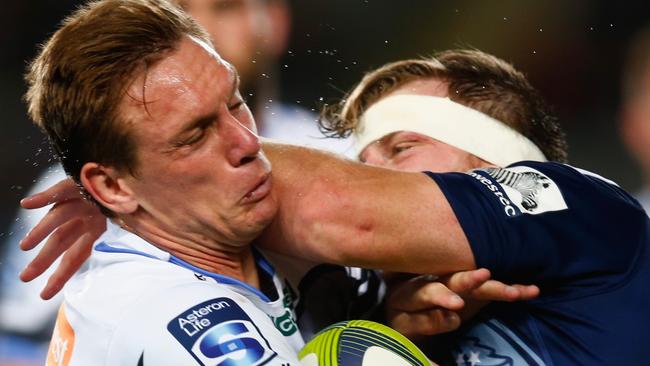 Dane Haylett-Petty of the Westen Force is tackled against the Blues.