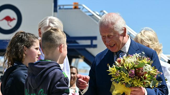 King Charles III talks to children after receiving flowers upon his arrival at Defence Establishment Fairbairn, Canberra Airport on October 21, 2024, in Canberra, Australia. Picture: NewsWire / POOL / Saeed Khan