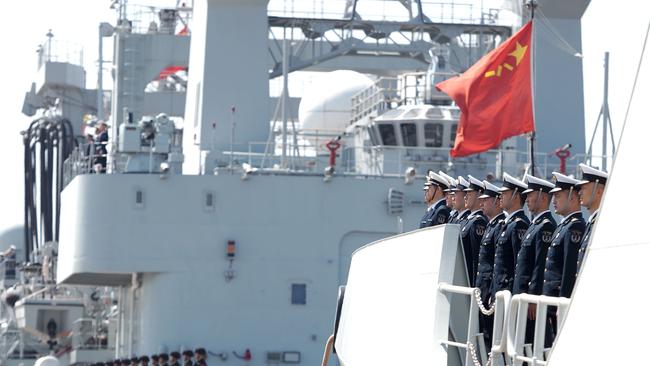 Officers and soldiers of the Chinese naval fleet for escort mission line up on the deck at a port in Zhoushan, east China's Zhejiang Province.