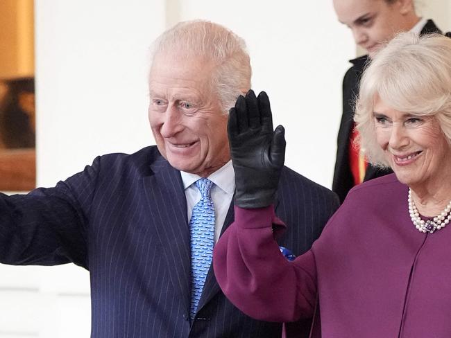 Britain's King Charles III and Britain's Queen Camilla wave as they formally bid farewell to Qatar's Emir Sheikh Tamim bin Hamad al-Thani and his wife Sheikha Jawaher bint Hamad bin Suhaim al-Thani at Buckingham Palace in central London, on December 4, 2024, on the second day of the Emir's two-day State Visit to Britain. The Emir of Qatar and his wife are in the UK for a two-day State Visit, hosted by Britain's King. (Photo by Aaron Chown / POOL / AFP)