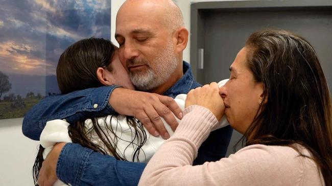 Former Israeli hostage Naama Levy is reunited with family at an army screening point in Reim, in southern Israel. Picture: Israeli Army/AFP
