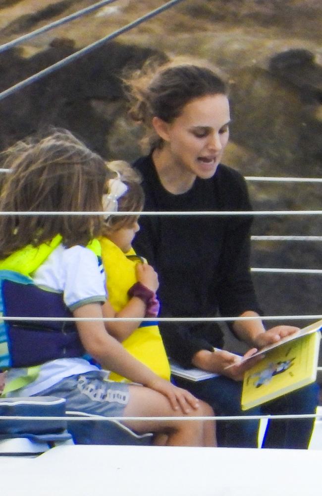 Natalie Portman reads a Bluey storybook to her children Amalia and Aleph on Sydney Harbour.