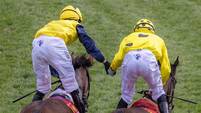 Mark Zahra (right) is congratulated by Jamie Spencer after winning the Caulfield Cup. Picture: Jason Edwards