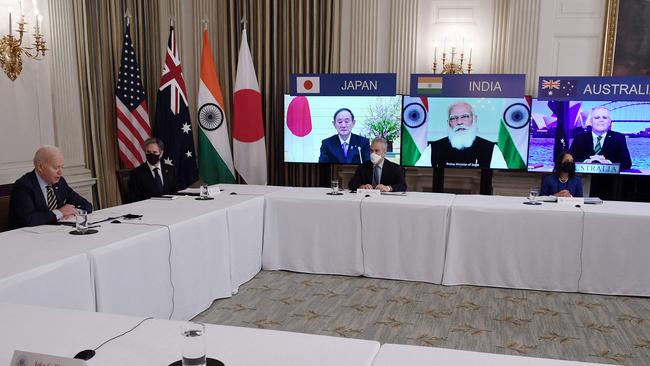 US President Joe Biden (L), with Secretary of State Antony Blinken (2nd L), meets virtually with members of the “Quad” alliance of Australia, India, Japan and the US, in the State Dining Room of the White House. Picture: AFP