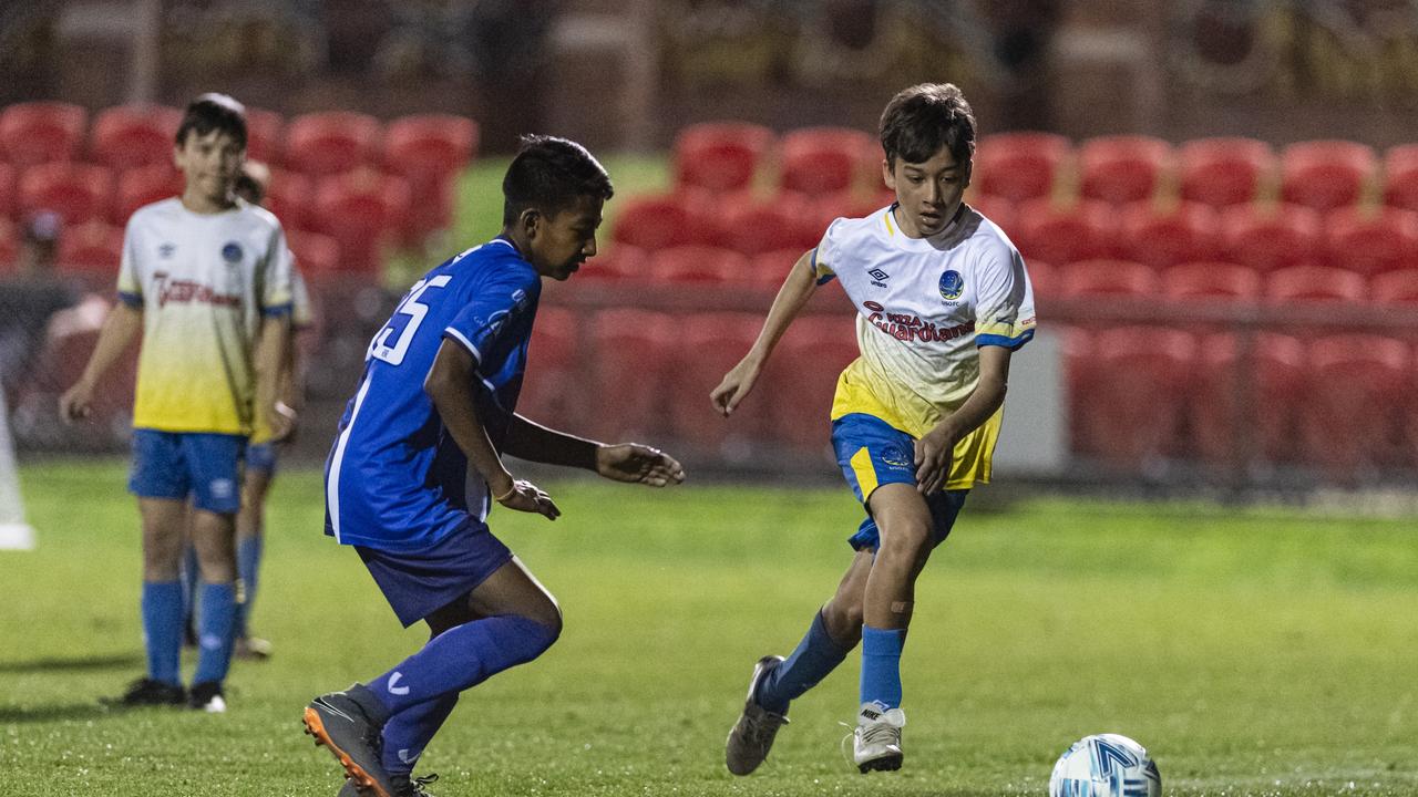 Priyanshu Shrestha (left) of Rockville Rovers White against Nashwan Ilyas of USQ FC in Football Queensland Darling Downs Community Juniors U13 Div 1 Maroon grand final at Clive Berghofer Stadium, Friday, August 30, 2024. Picture: Kevin Farmer