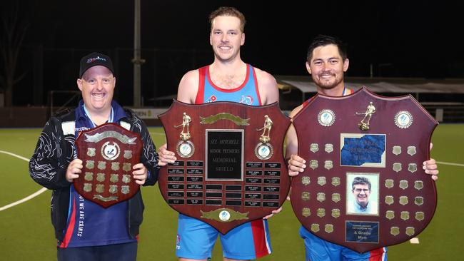 Saints “supercoach” Glen Waters and co-captains Cameron Anderson and Ryan Coffey hold the victors’ shields after winning the Cairns Hockey Association A Grade Men's grand final match against Souths. PICTURE: BRENDAN RADKE