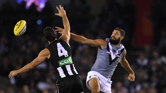 Brodie Grundy of the Magpies (left) and Patrick Ryder of the Power battle in the ruck. Picture: AAP Image/Julian Smith