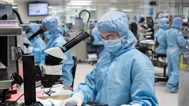 Workers on the production line building new Cochlear Implants at Cochlear, Sydney. Picture: NCA NewsWire / James Gourley