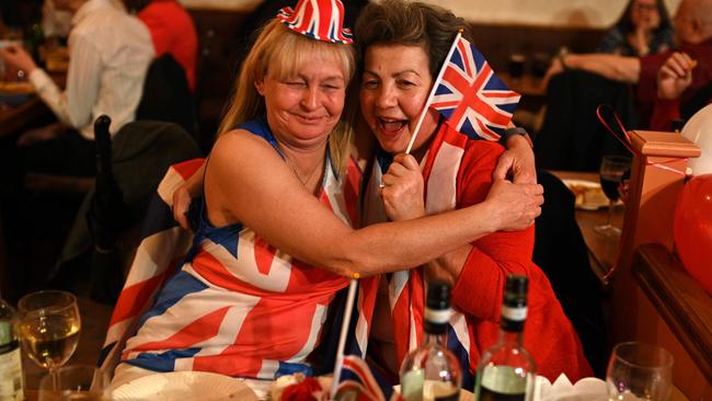 Brexit supporters embrace during a Brexit Celebration party at Woolston Social Club in Warrington, north west England. Picture: AFP