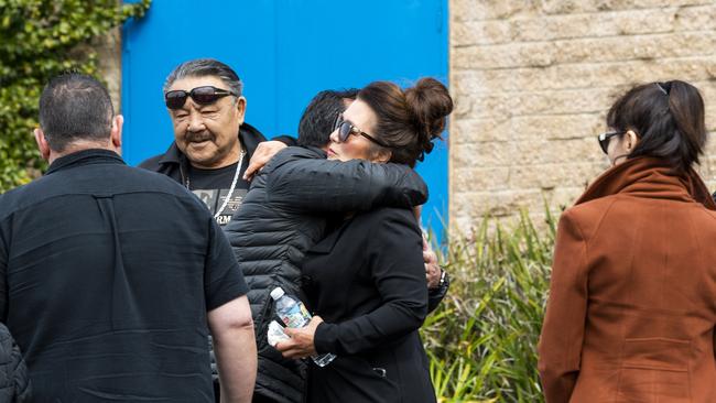 Mourners hug each other at the emotional funeral. Picture: NCA NewsWire / Monique Harmer