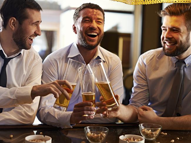 Three joyful men toasting with beer