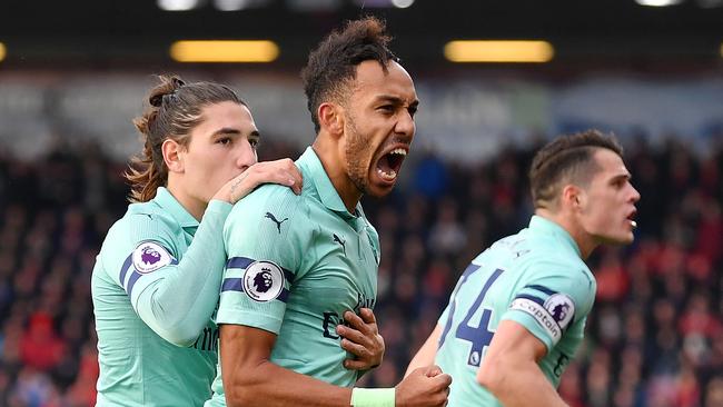 Pierre-Emerick Aubameyang of Arsenal (centre), defender Hector Bellerin (left) and midfielder Granit Xhaka (right) celebrate after Aubameyang scored the winner against Bournemouth. Photo: Getty Images