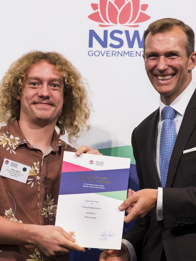 Narrabeen’s Toby Jones of Covenant Christian School receives an equal first place for French Beginners from Education Minister Rob Stokes. Photo: Anna Warr