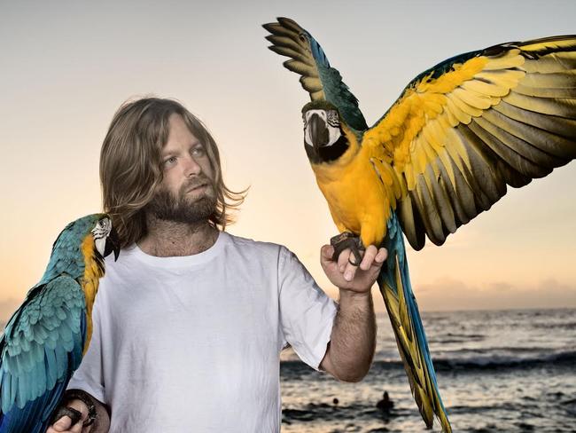 Bird trainer and rescuer Josh Cook with his macaws Mango and Crush.