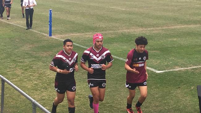 Marsden SHS year 10 student Terry Lafoai, middle, leaves the field at halftime against St Brendan's last year