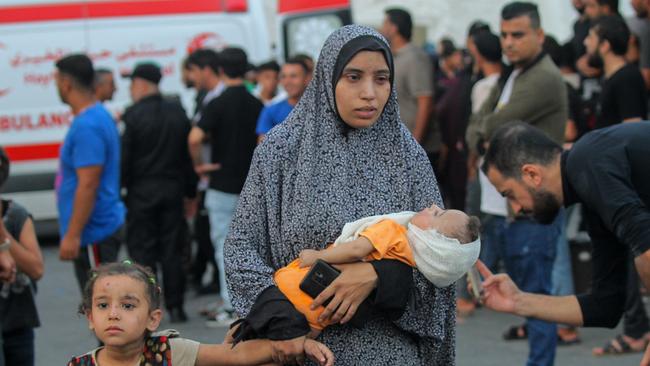 Wounded Palestinians, injured following Israeli air raids, visit Al-Shifa Hospital for treatment in Gaza City.