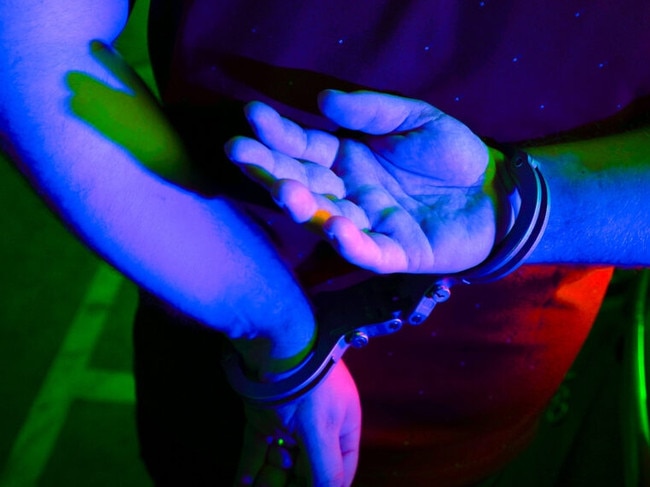Cairns police generic handcuffs night