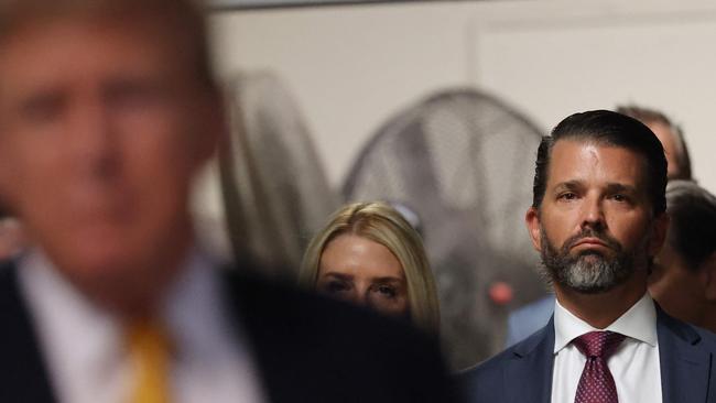 Donald Trump, Jr., looks on as father Donald Trump speaks to the press at Manhattan Criminal Court on Tuesday, (Photo by Michael M. Santiago / POOL / AFP)