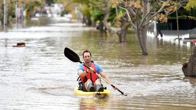 A man kayaks through floodwater in Maribyrnong. Picture: Nicki Connolly