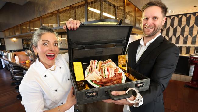 Brendan Gamze, with a briefcase of Gamze Gold bacon sangers, with cookbook author Sarah Kiryshin. Picture: David Caird