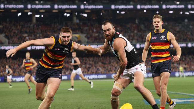 Mark Keane battles Charlie Dixon on his Crows debut. Picture: Sarah Reed/AFL Photos via Getty Images