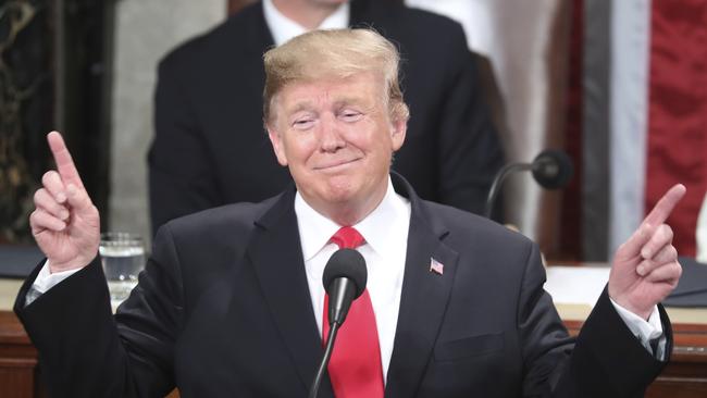 Donald Trump takes a break from his State of the Union address on Capitol Hill in Washington on Wednesday to play conductor as people sing Happy Birthday to Holocaust survivor Judah Samet, 81. Picture: AP