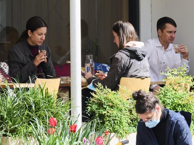 CANBERRA, AUSTRALIA - OCTOBER 15: Patrons enjoy sitting down and eating in at a cafe on October 15, 2021 in Canberra, Australia. Lockdown restrictions have eased in Canberra with over 70% of the eligible community now fully vaccinated in the ACT. Restrictions will continue to ease slowly in the coming weeks and months. As of 11:59 pm on Thursday, up to five people are permitted to visit another household and up to 25 people can gather outdoors. Hospitality and recreation facilities are able to reopen subject to density limits while outdoor team sport can resume. Retail can reopen for a click and collect shopping, or booked appointments for up to two people in a retail store. Travel restrictions have also been eased to allow travel to surrounding NSW postcodes. (Photo by Rohan Thomson/Getty Images)