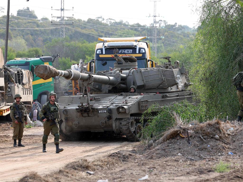 Israeli troops gather with their military equipment at an undisclosed location on the border with the Gaza Strip. Picture: AFP