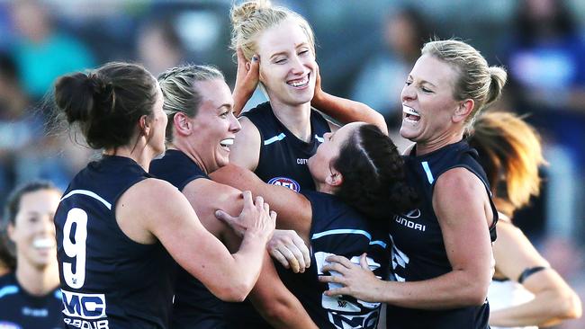 Kate Shierlaw celebrates a goal with teammates.