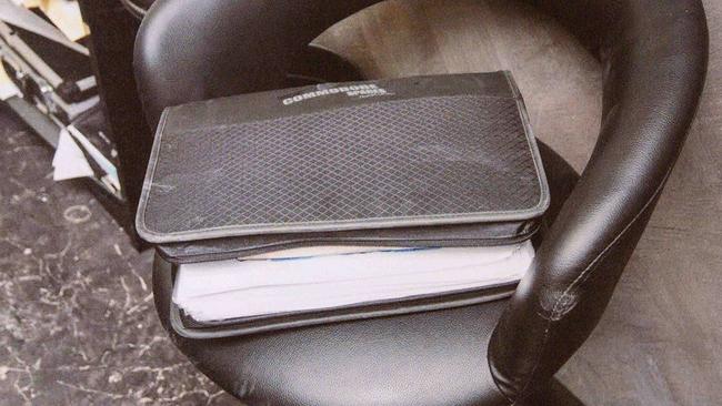 A black folder containing paperwork and $6000 found in the warehouse. Picture released by Supreme Court.