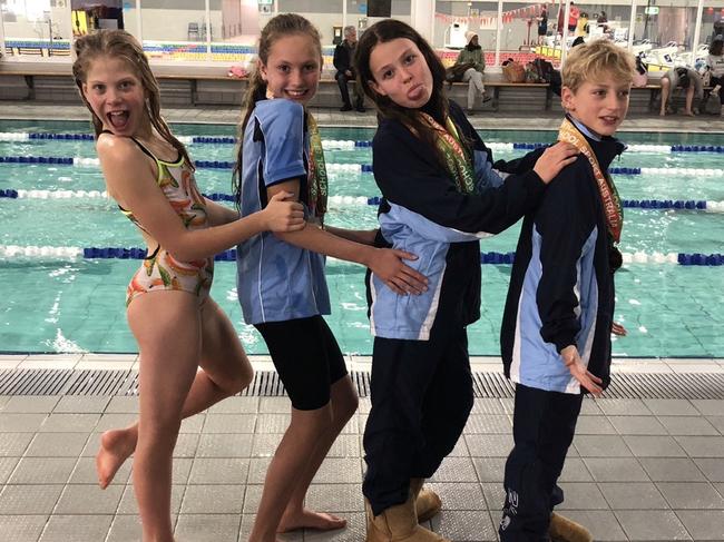 The girls with fellow Warringah swimmer Noah McLaren, who won relay gold.